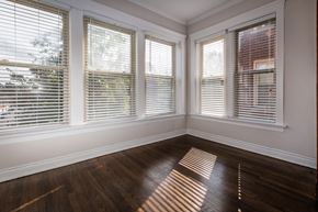 Chicago apartment for rent - an empty room with wooden floors and windows