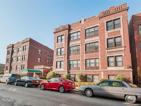 Chicago apartment for rent - a row of cars parked in front of a brick building