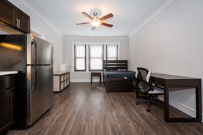 Chicago apartment for rent - a kitchen and living room with a refrigerator and a desk