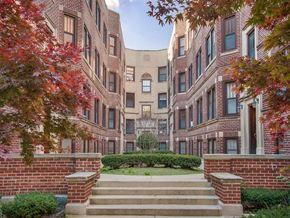 Chicago apartment for rent - a view of an apartment building with stairs and a garden