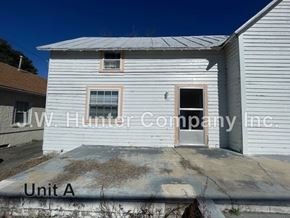 Stantonsburg apartment for rent - A white building with the words "Unit A" written on the ground in front of it.