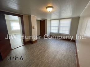 Stantonsburg apartment for rent - A room with wooden flooring and a door is labeled as Unit A.