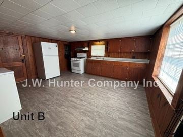 Stantonsburg apartment for rent - A kitchen area with wooden cabinets and a white refrigerator.