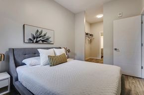 Edmonton apartment for rent - a bedroom with a large bed and a white closet