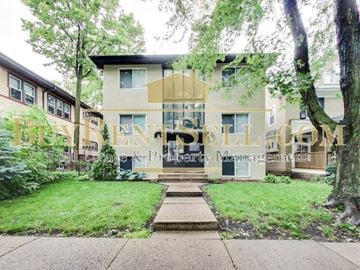 Minneapolis apartment for rent - front view of a house with trees and grass