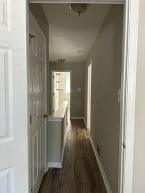 Philaladephia house for rent - A long hallway with white doors and wood floors.