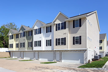 Davenport apartment for rent - a row of houses with white siding and white garage doors