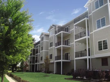 Davenport apartment for rent - an apartment building with green grass and trees