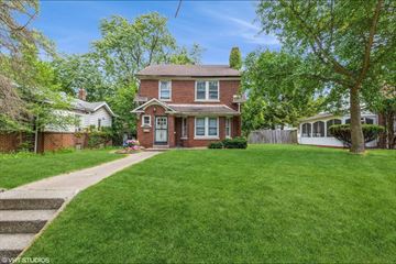 Gary house for rent - a red brick house with a lawn and a sidewalk