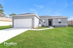Palm Bay house for rent - a white house with a lawn in front of it