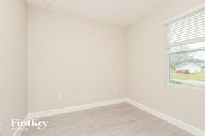 Palm Bay house for rent - a bedroom with a large window and a wooden floor