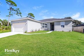 Palm Bay house for rent - a white house with a lawn in front of it