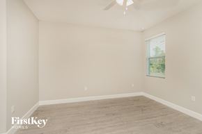 Palm Bay house for rent - a bedroom with a wood floor and a ceiling fan