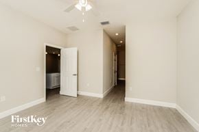 Palm Bay house for rent - a living room with white walls and a ceiling fan