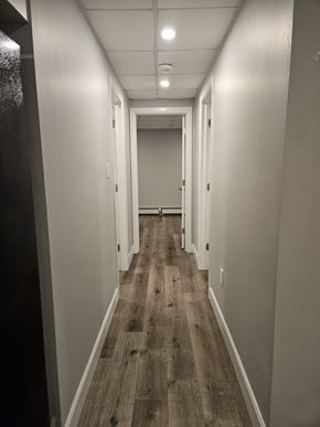 London apartment for rent - A long hallway with wood floors and white walls.