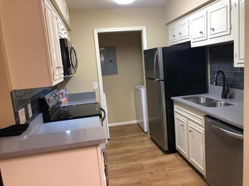 Nashville apartment for rent - A kitchen with black appliances and white cabinets.