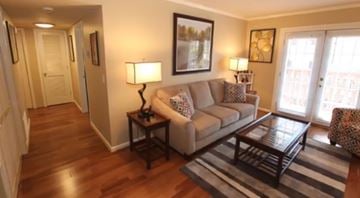 Nashville apartment for rent - A living room with a couch, coffee table, and lamp.