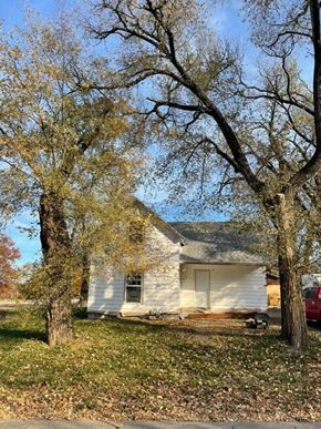 Clinton house for rent - a white house with two trees in front of it