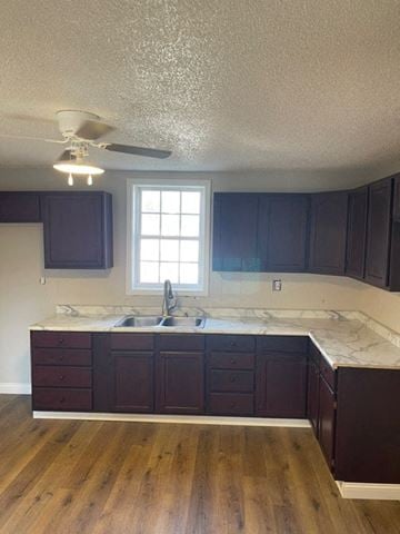 Clinton house for rent - a kitchen with dark cabinets and a sink and a window