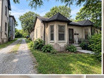 London apartment for rent - A house with a black roof and a gravel driveway.