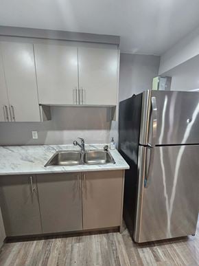 London apartment for rent - A kitchen with a sink and a refrigerator.