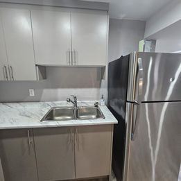 London apartment for rent - A kitchen with a sink and a refrigerator.