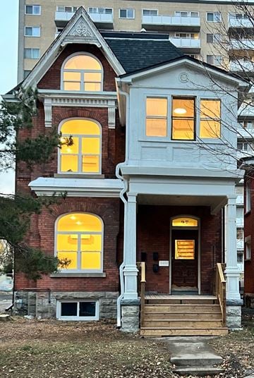 Ottawa apartment for rent - the front of a brick house with yellow windows