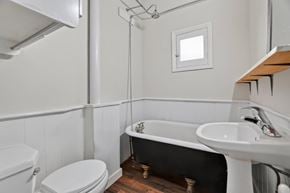 London apartment for rent - A white toilet sits next to a white sink in a small bathroom.