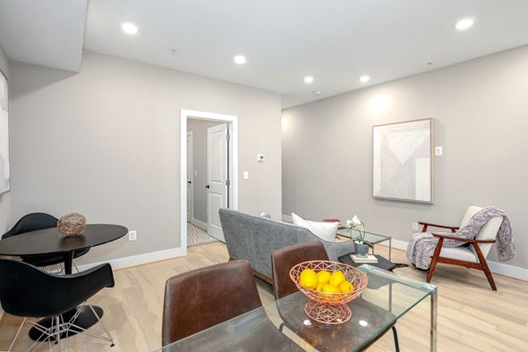 Washington apartment for rent - a living room with a glass table with a bowl of fruit on it