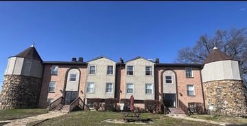 Clarksville apartment for rent - A row of houses with stone pillars in front.