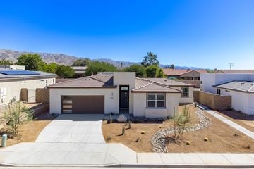 Desert Hot Springs house for rent - an aerial view of a house with a yard and mountains in the background