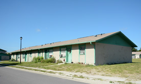 Hudson apartment for rent - A green and white building with a green roof and a street light in front.