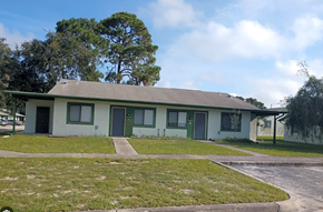 Hudson apartment for rent - A small building with a green door and a grey roof.