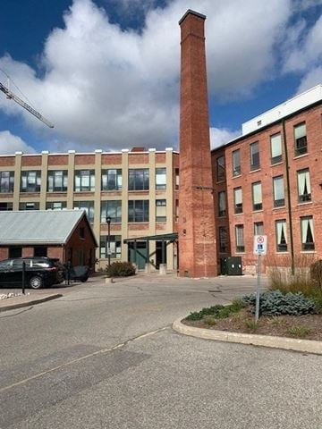Guelph apartment for rent - a large brick building with a tall brick tower