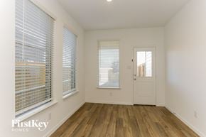 Fort Worth house for rent - a living room with wood floors and a white door
