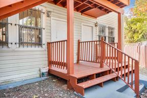 Washington apartment for rent - a front porch with a red railing and a porch swing