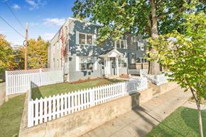 Washington apartment for rent - a blue house with a white fence in front of it