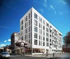 Newark apartment for rent - A white building with many windows is the main focus of the image.