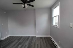 Philadelphia apartment for rent - A room with a ceiling fan and a window.