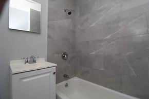 Philadelphia apartment for rent - A white bathroom with a tub and sink.