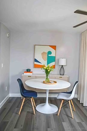 Philadelphia apartment for rent - A dining room with a white table and blue chairs.