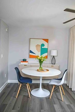 Philadelphia apartment for rent - A dining room with a white table and blue chairs.