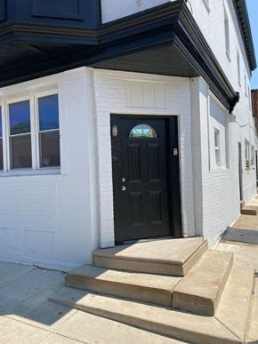 Philadelphia apartment for rent - A black door is on the front of a white house.