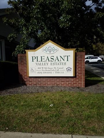Mount Carmel apartment for rent - a sign for pleasant valley estates in front of a brick wall