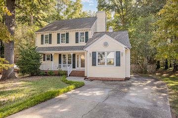Raleigh house for rent - A house with a white front porch and green shutters.