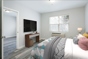 Philadelphia apartment for rent - A bedroom with a bed, a television, and a window.