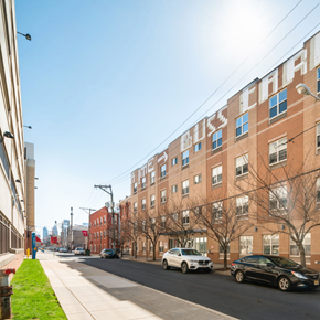 Philadelphia apartment for rent - A street view of a residential area with cars parked on the side of the road.