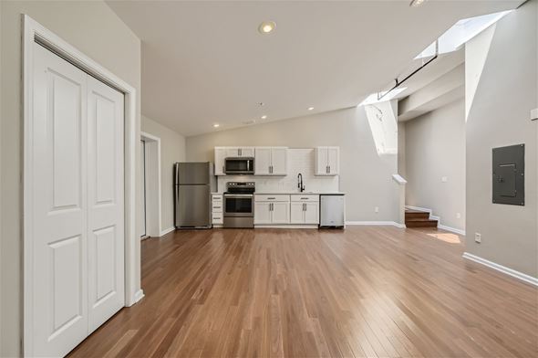 Baltimore apartment for rent - A kitchen with white cabinets and a wooden floor.