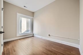 Baltimore apartment for rent - A room with a window and wooden flooring.