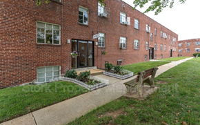 Baltimore apartment for rent - a bench in front of a brick building